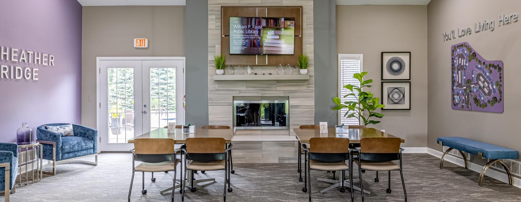 a room with a fireplace and a table with chairs