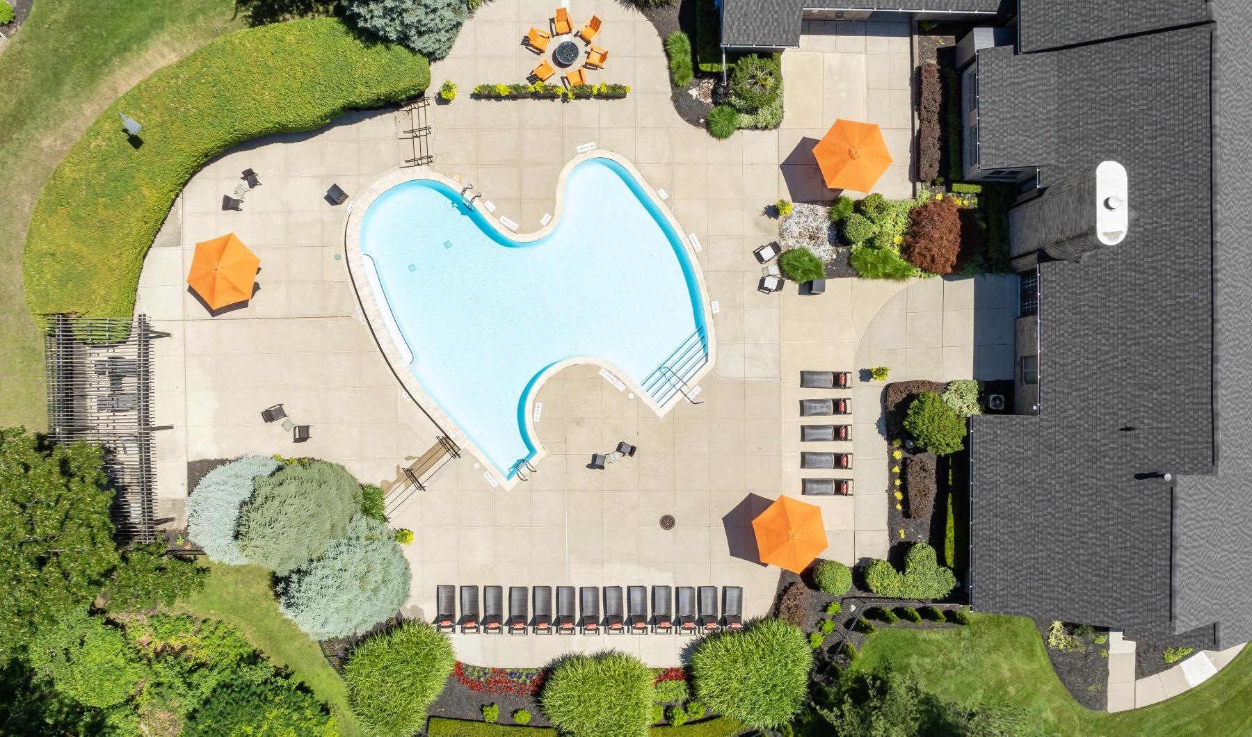 aerial view of a pool behind a building