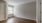 a room with a wood floor and white doors
